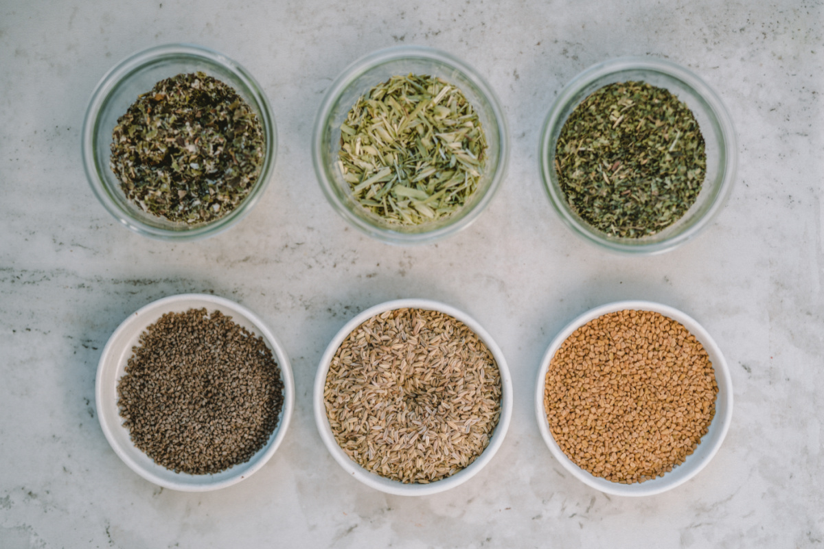 glass bowls of herbs to make healthy nursing tea