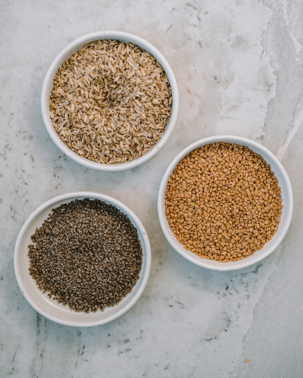 herb seeds in white bowls