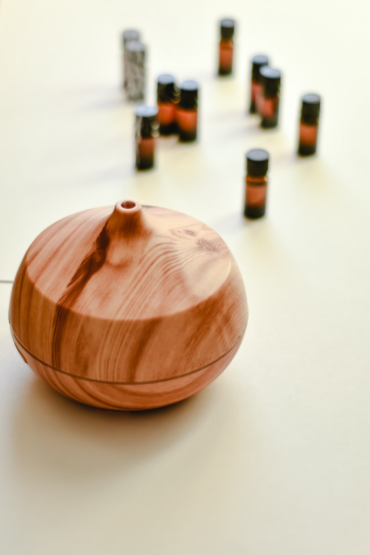 a diffuser with essential oils in the background