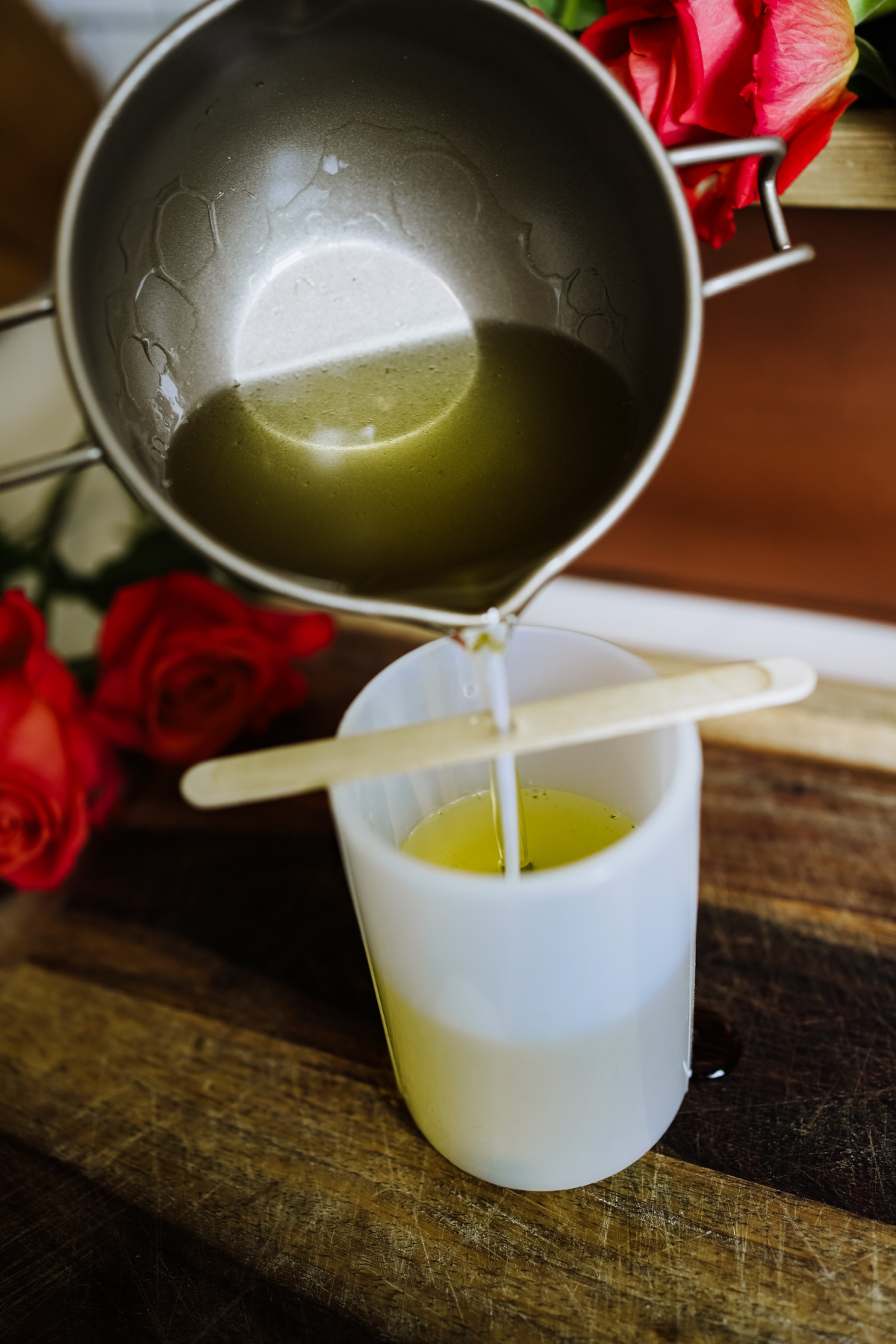 pouring melted soy wax into candle mold