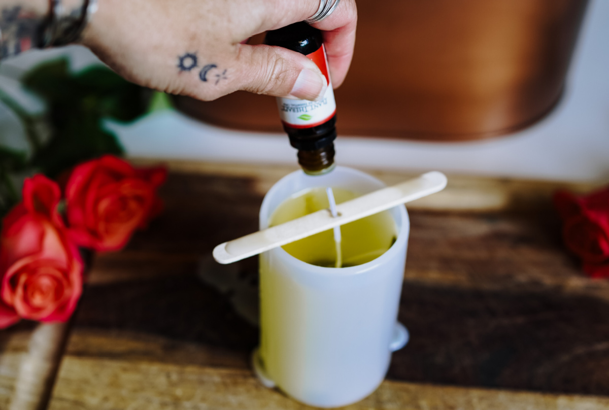 dropping essential oil onto candle