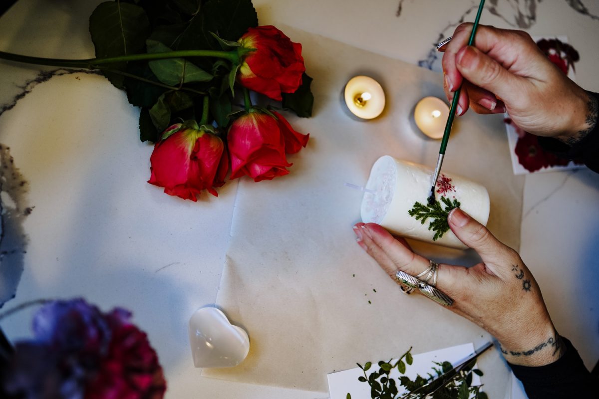 painting herb onto candle