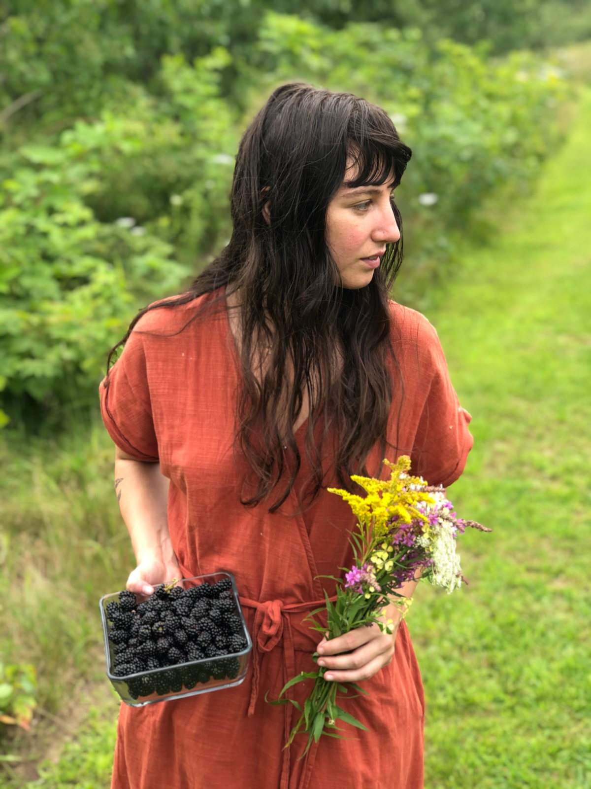 Madison Safer holding berries and wildflowers