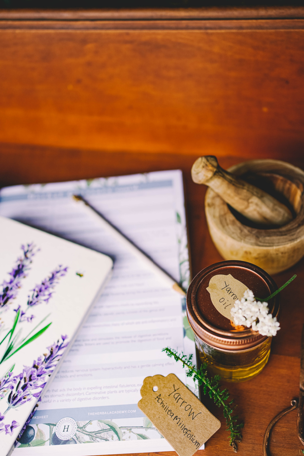 yarrow oil and books on a table