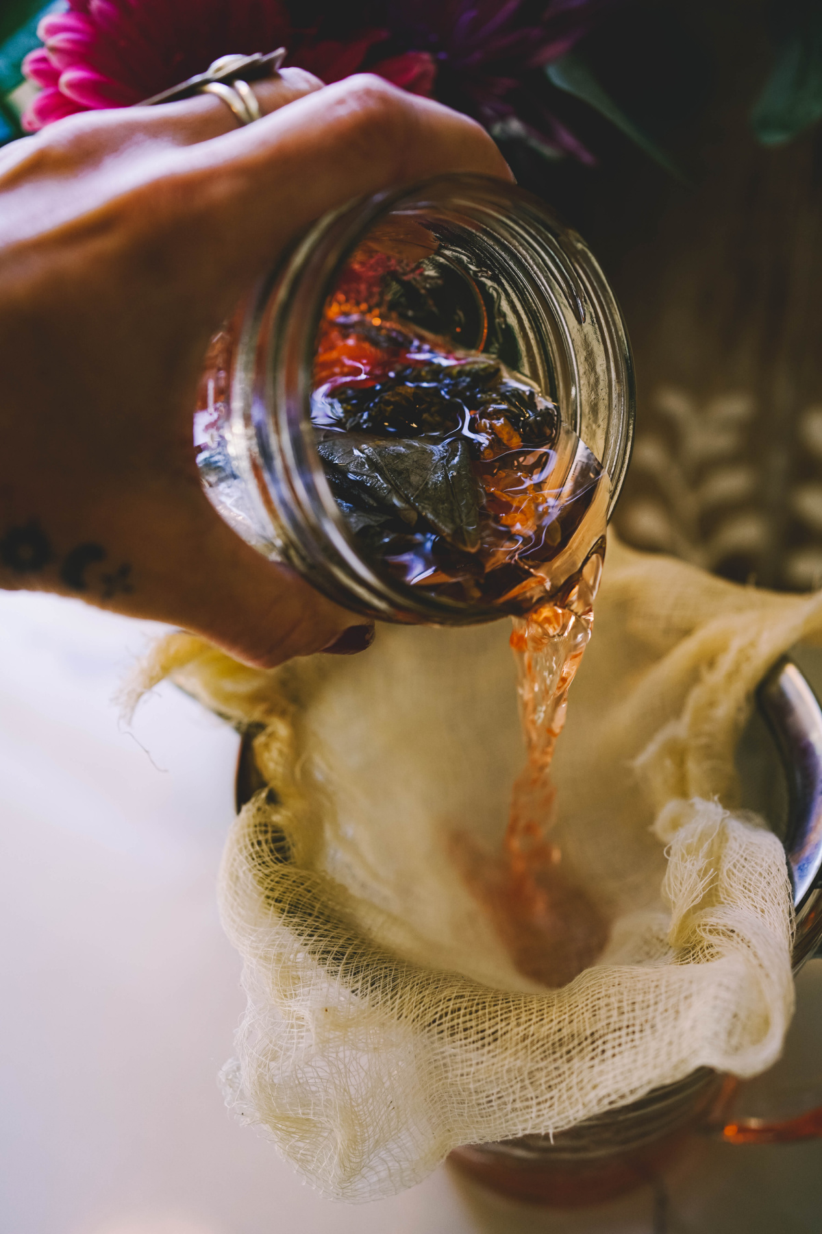 straining floral vinegar infusion