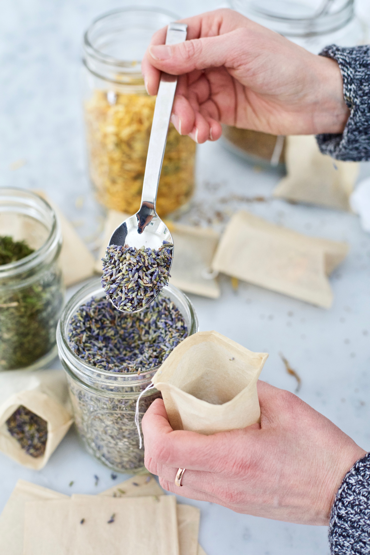 placing dried lavender into a tea bag