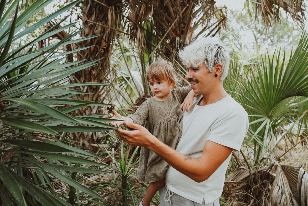 man showing girl a plant