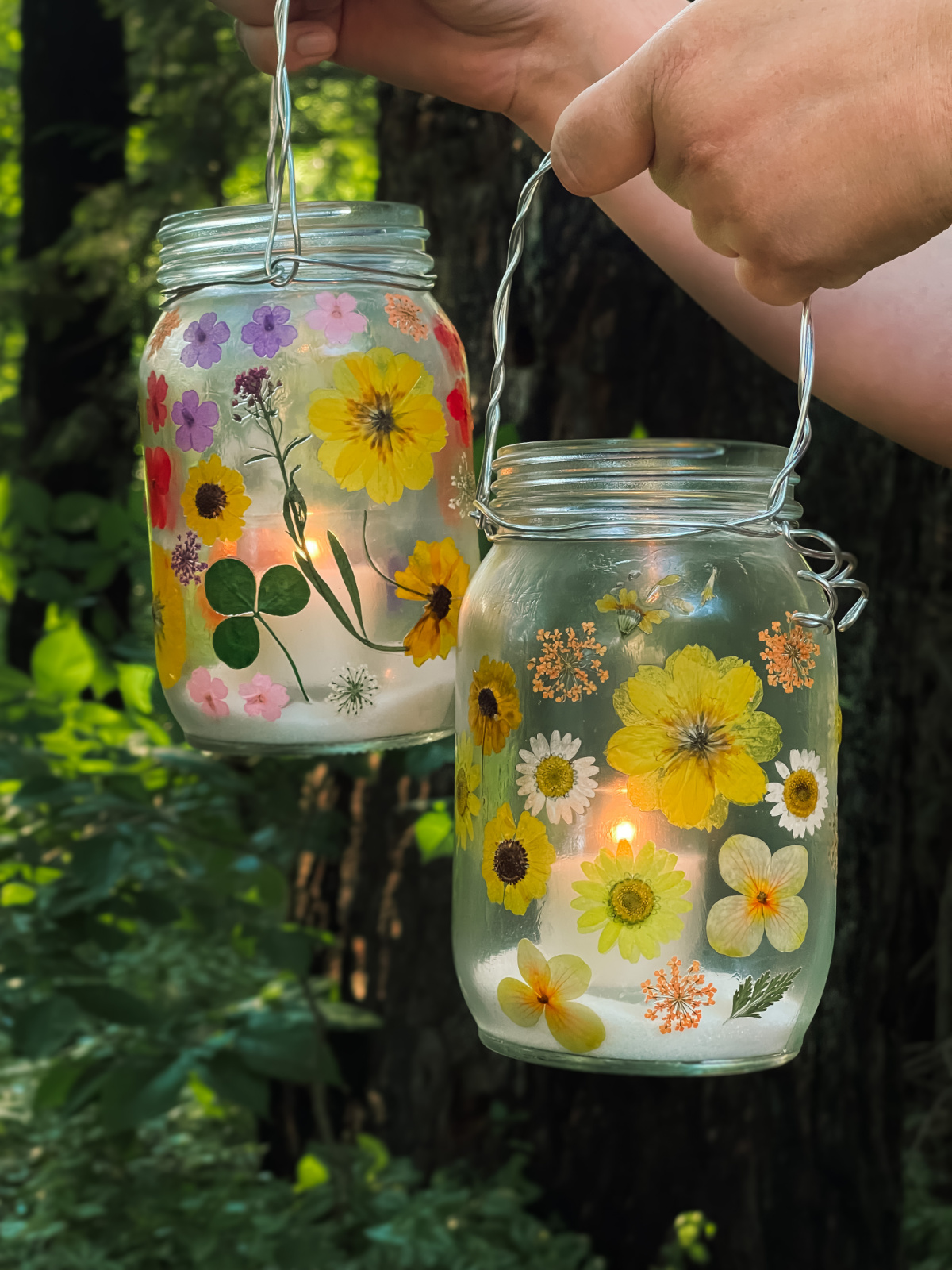 hands holding flower lanterns