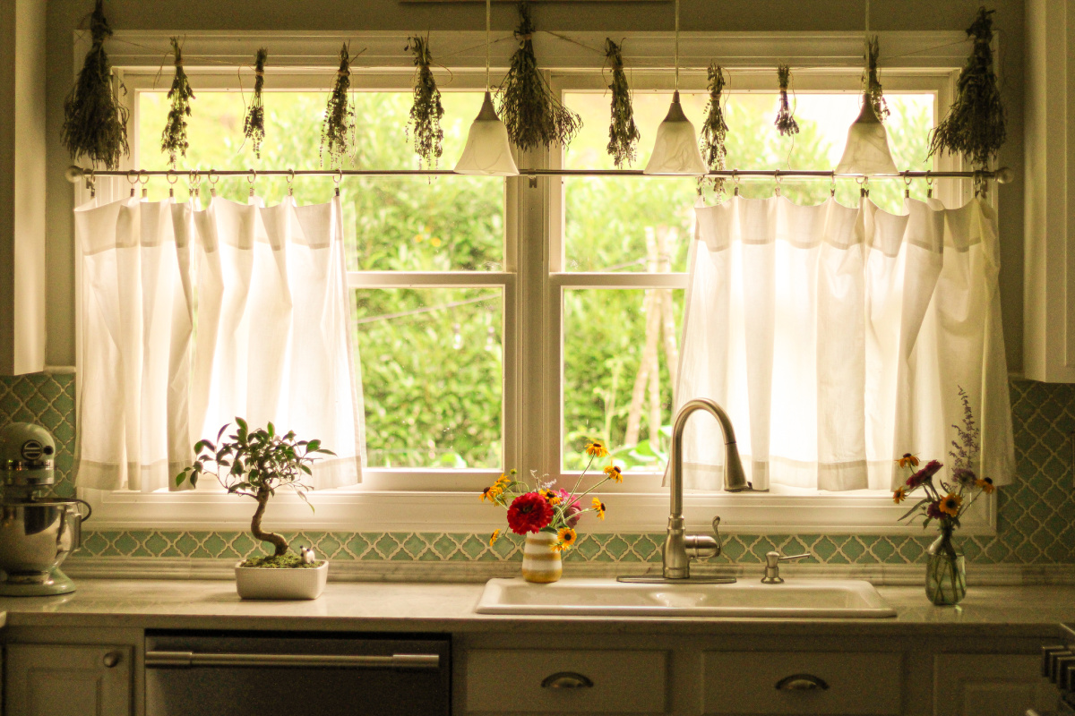 dried herb bundles hanging in kitchen window