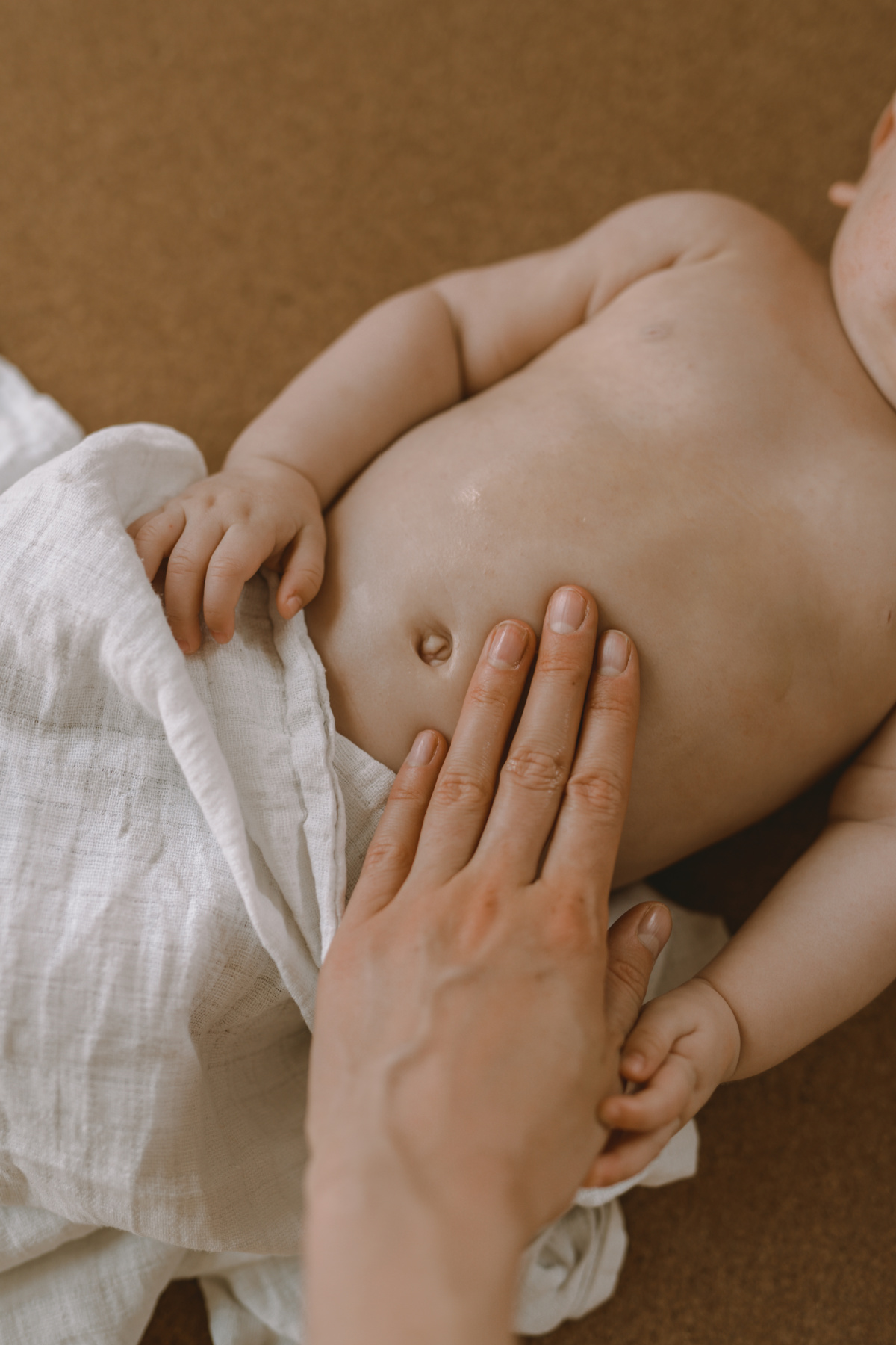 applying oil to baby's bells