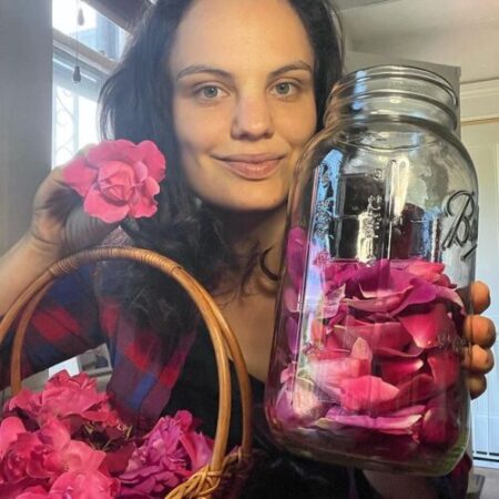 Ann Booth Cohen holding jar and basket of roses