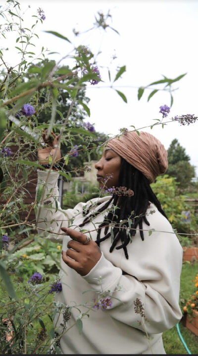 woman next to herbs