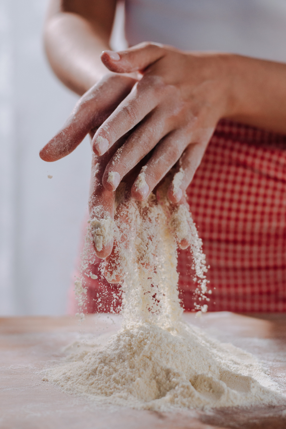 hands mixing flour