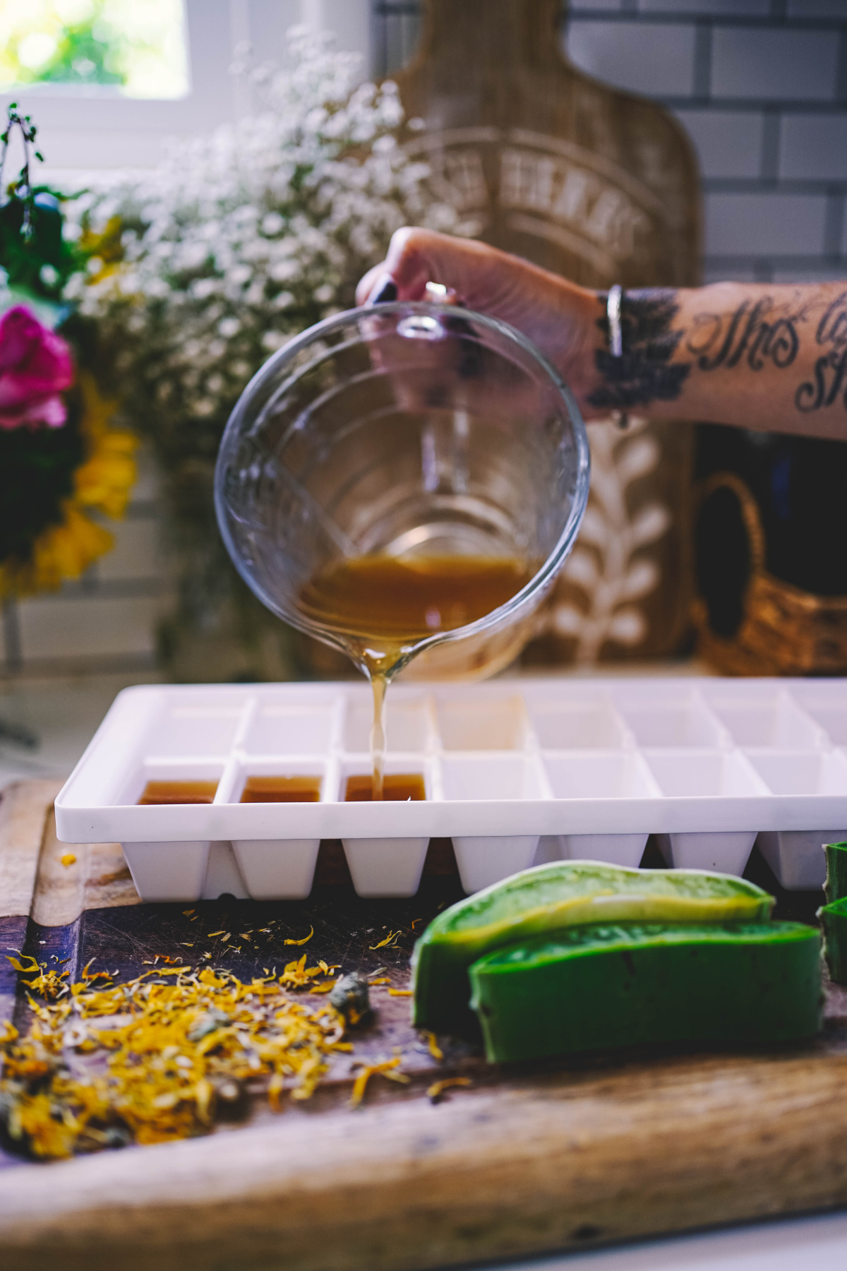 pouring infusion into ice cube tray