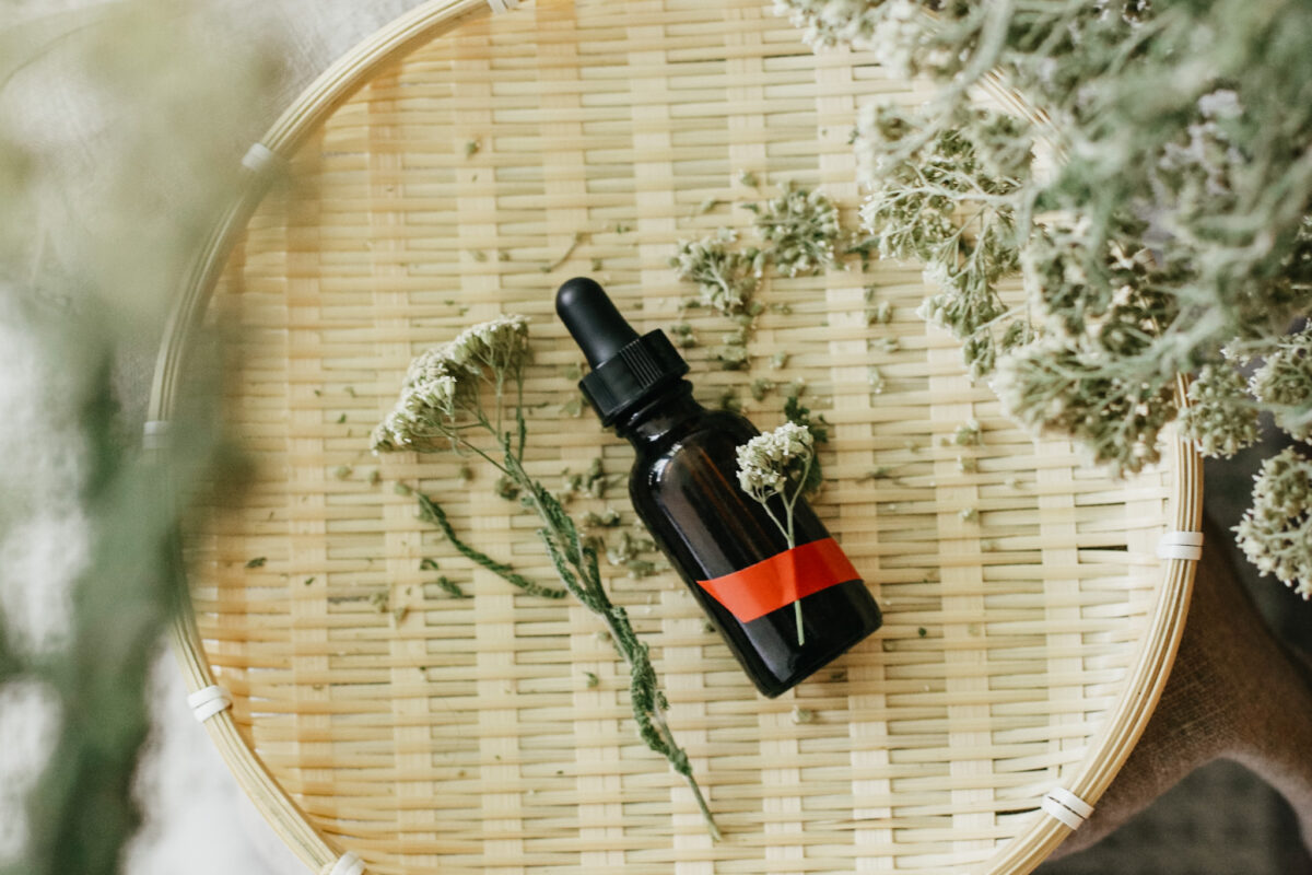 bottle of yarrow tincture laying on a basket