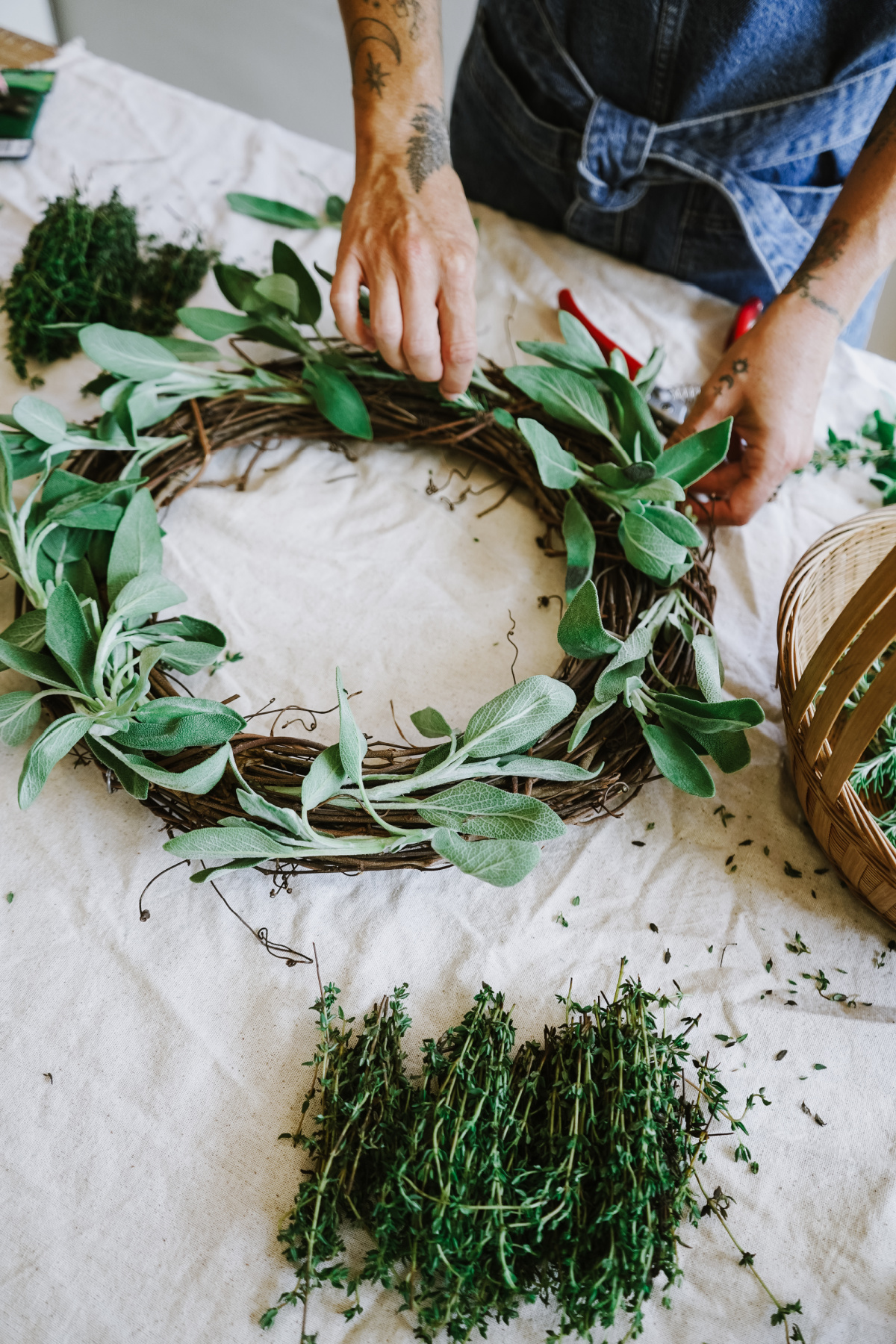 placing herbs on culinary wreath