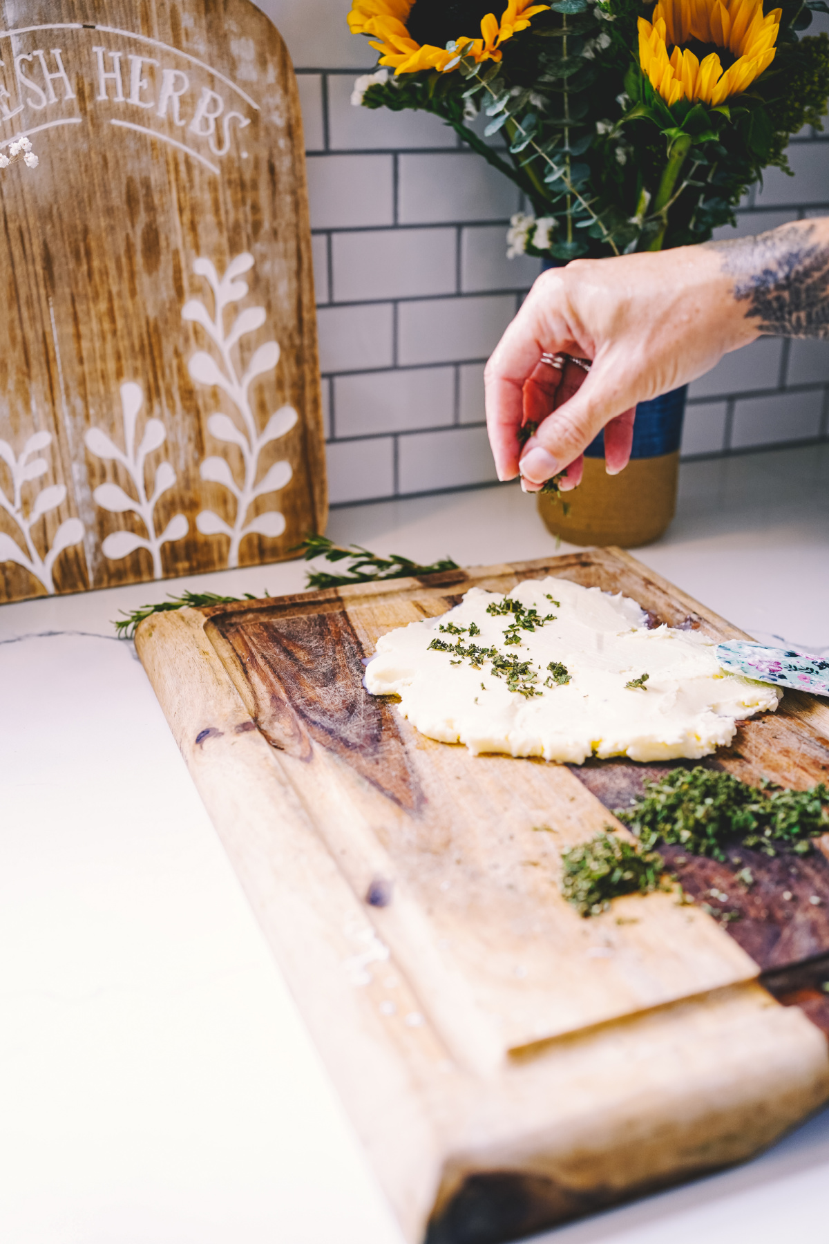 sprinkling herbs on butter