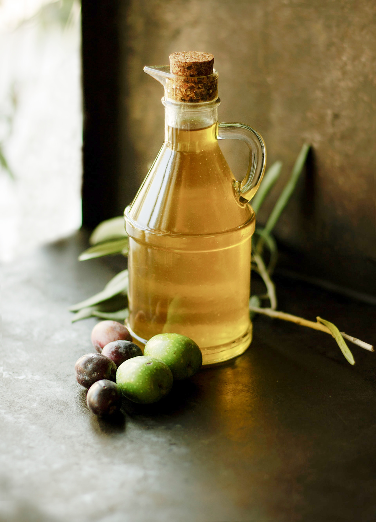 olive oil on a table with olives 