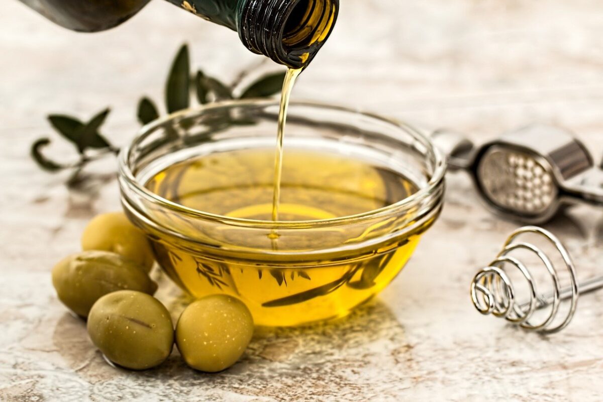 olive oil pouring in glass bowl