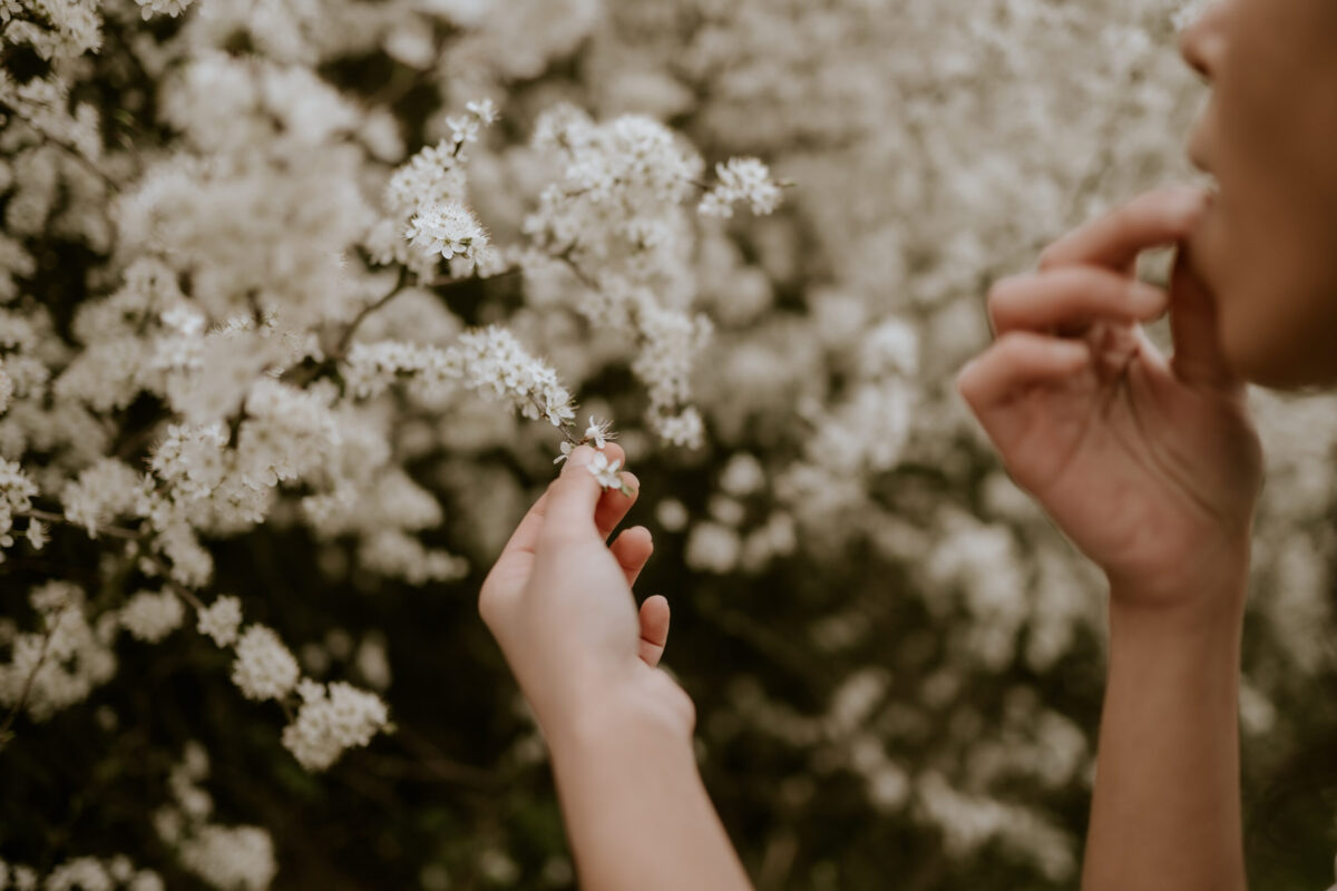 woman foraging and tasting flowers