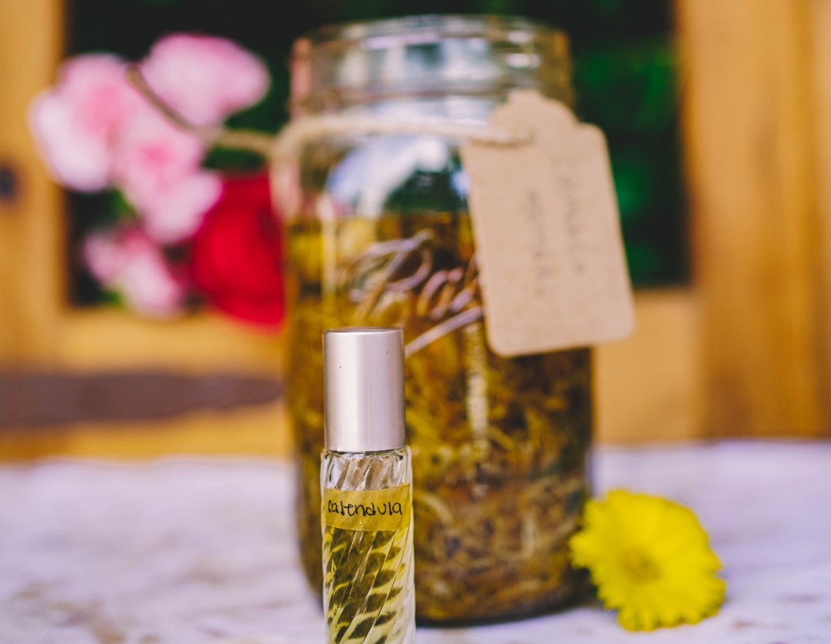 jar and roller bottle of calendula oil