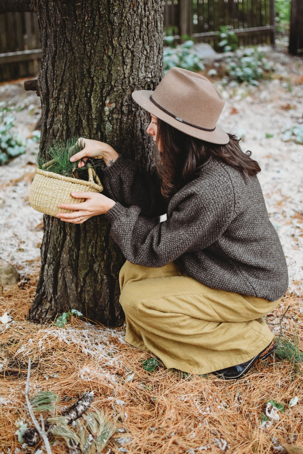 woman harvesting evergreens