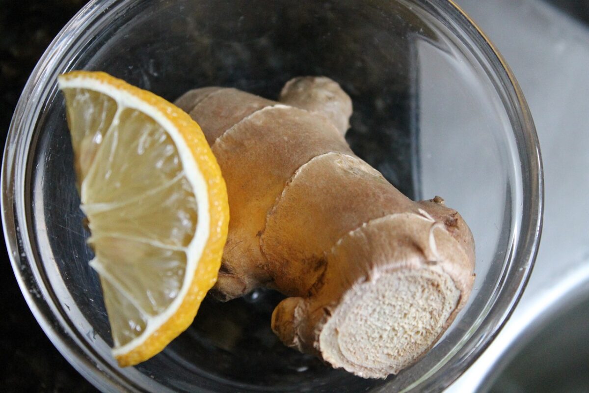ginger root and slice of lemon in a glass bowl