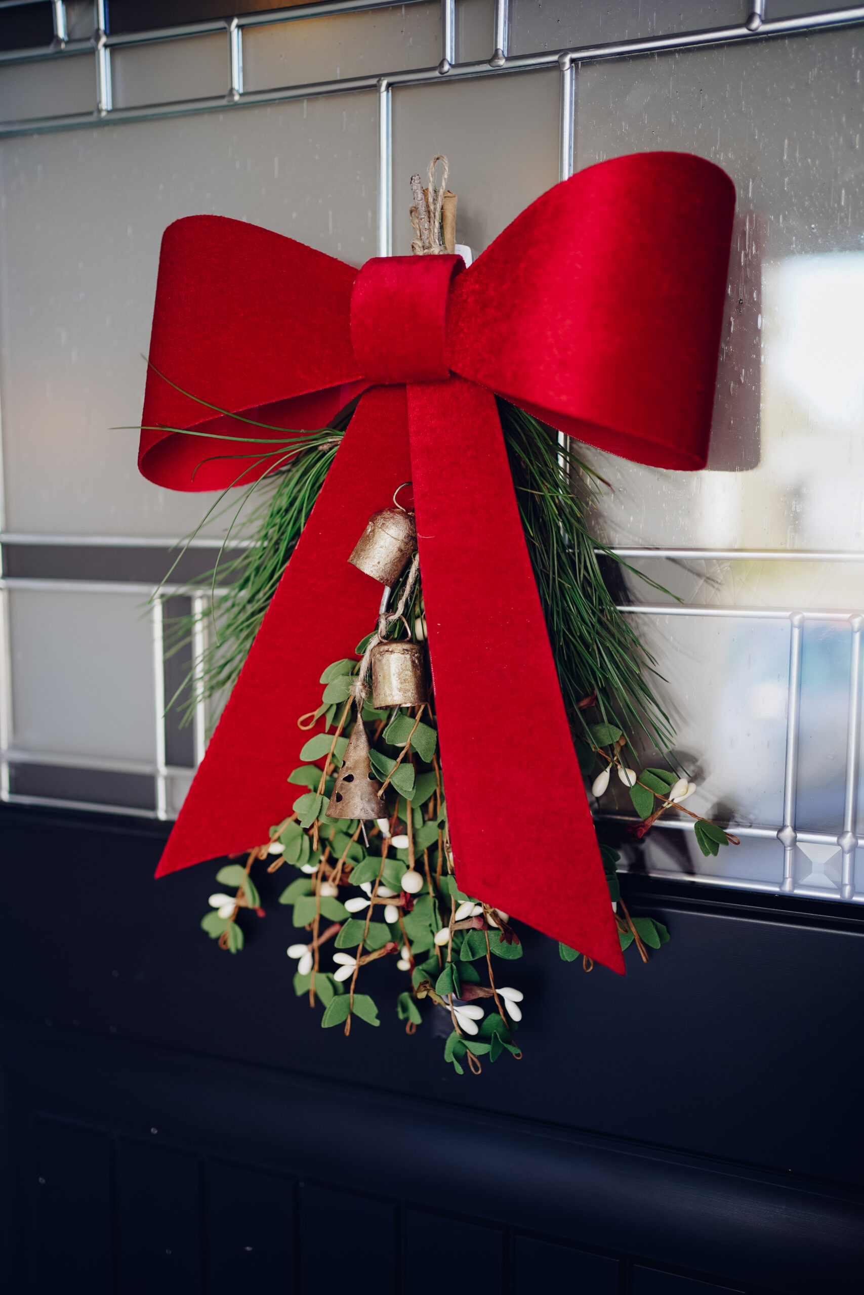mistletoe hanging with greenery and a red bow
