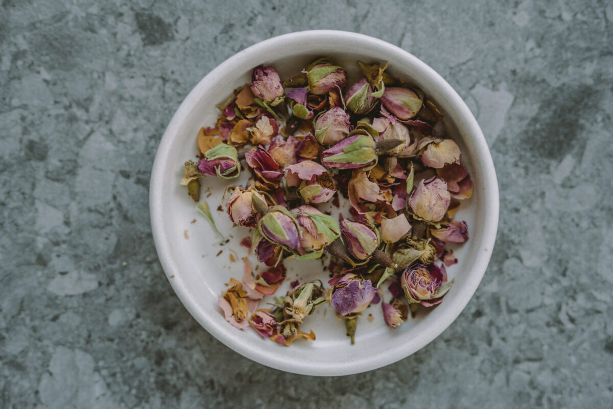 dried rose buds in a glass bowl