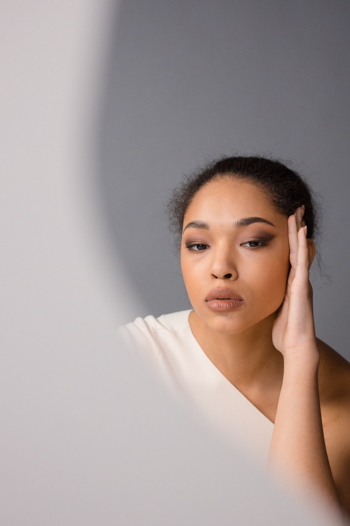 woman looking in mirror