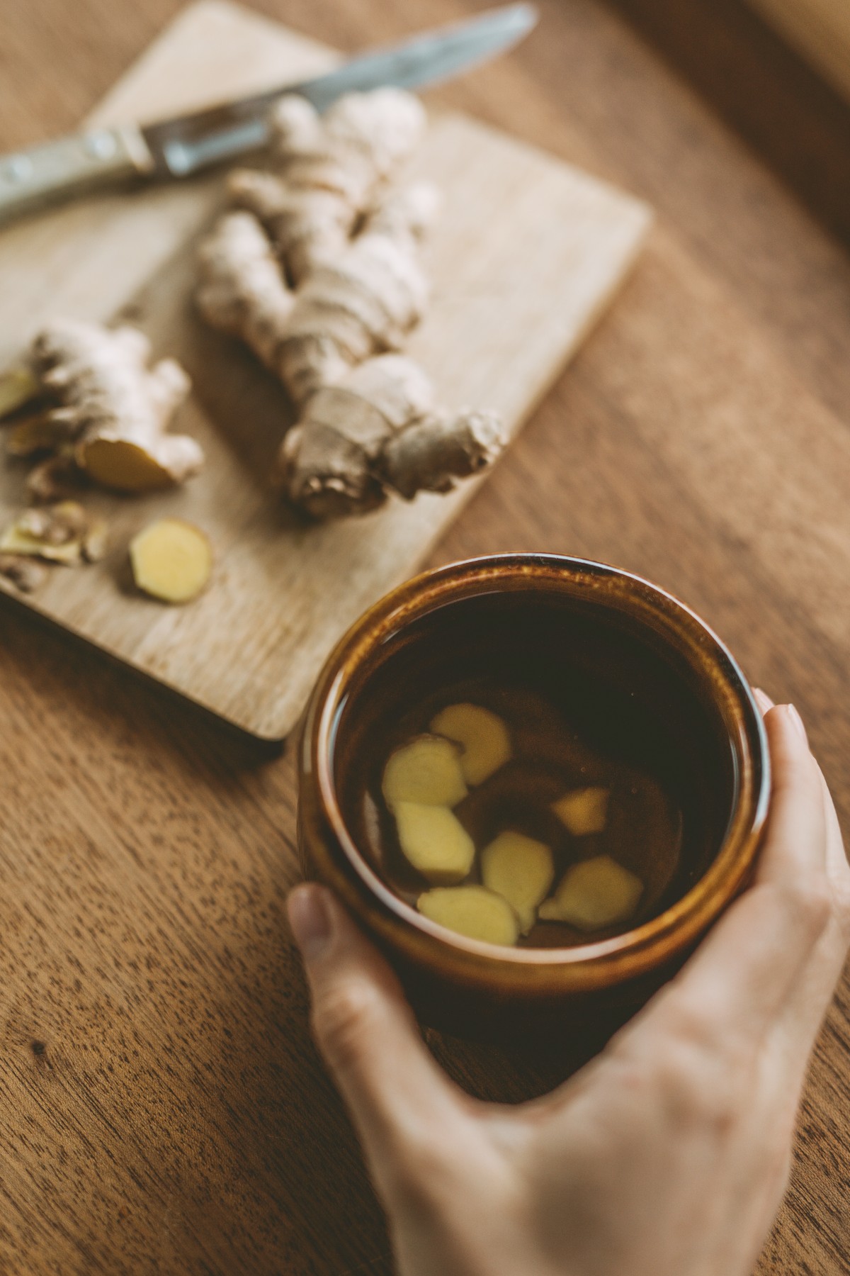 ginger on a cutting board and cup of ginger