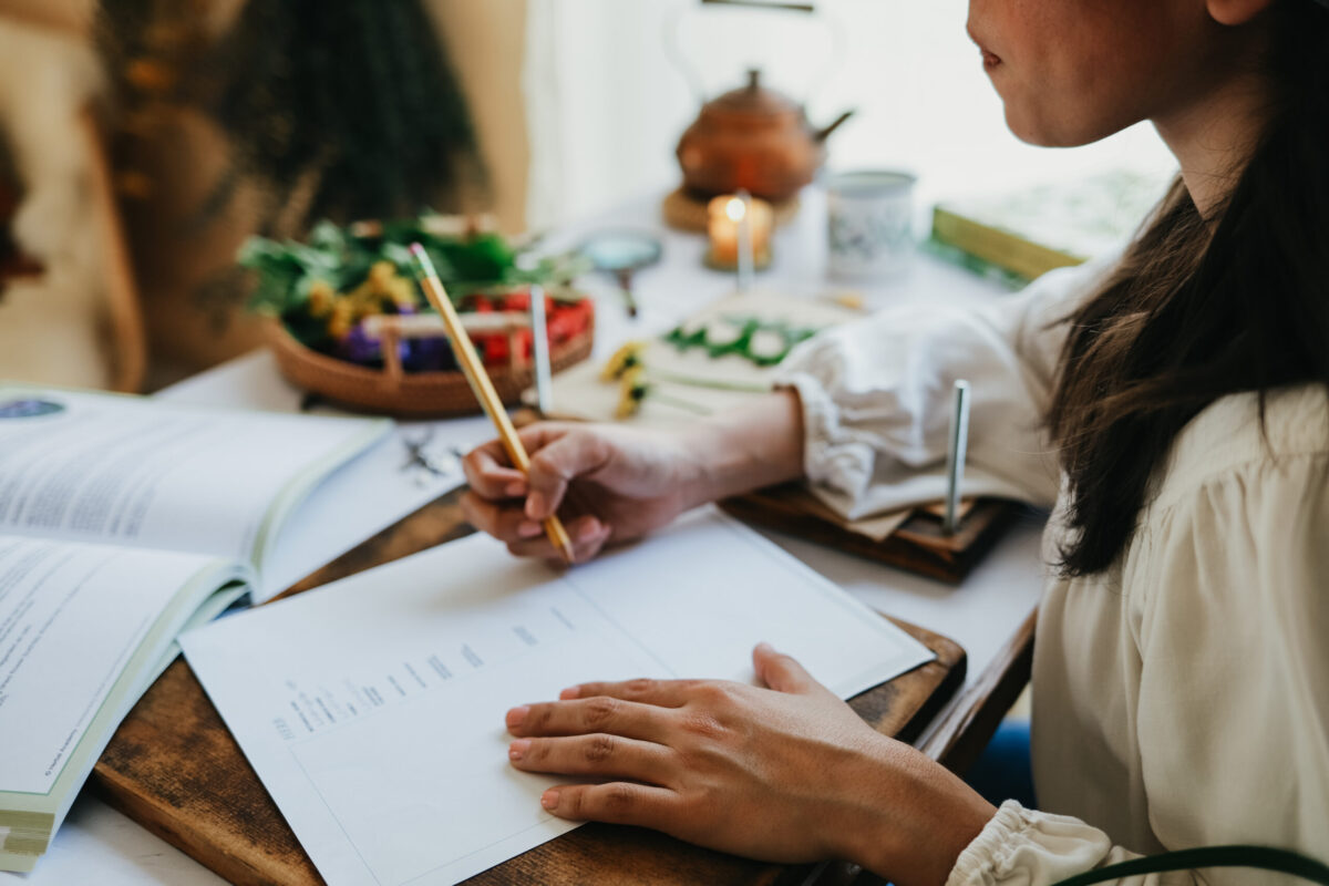 woman writing on piece of paper