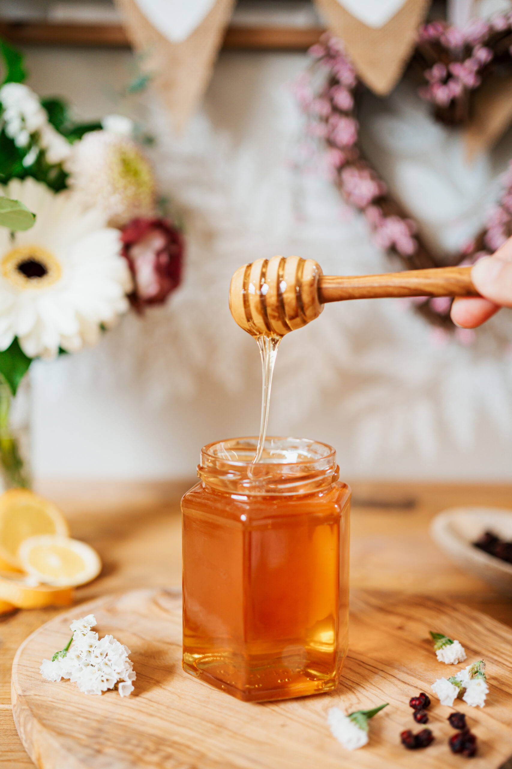 honey drizzling into a jar