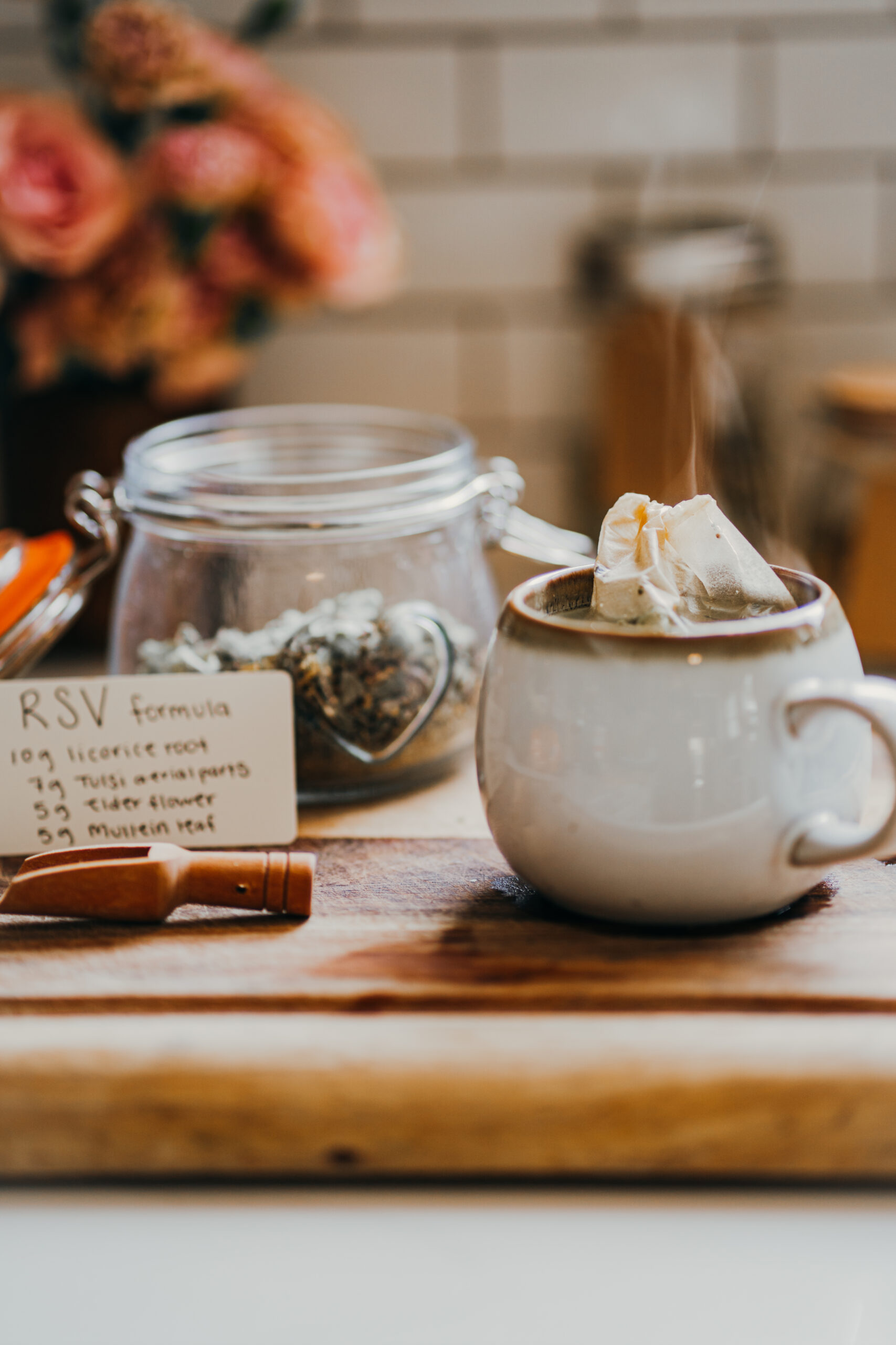 RSV Formula recipe card with a jar of dried herbs and a mug of tea