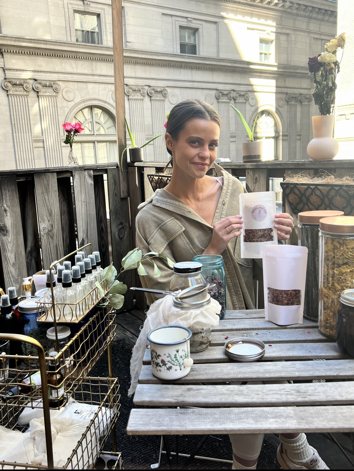 woman surrounded by herbal products she creates