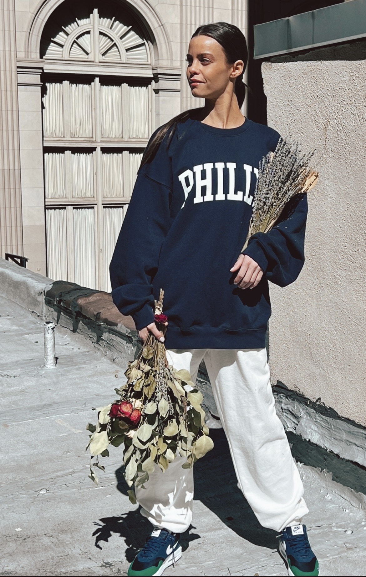 woman holding flowers and looking off to the side