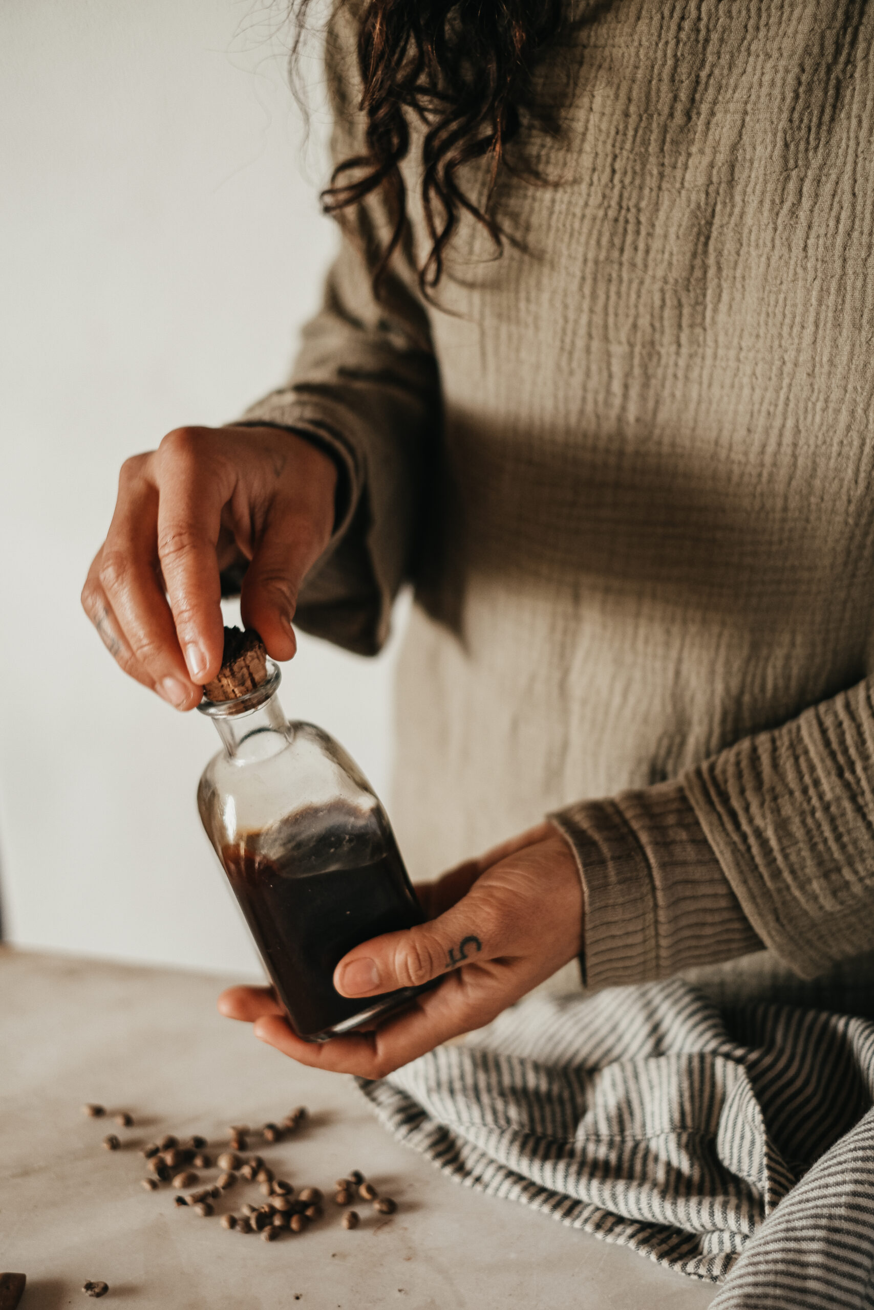 woman holding bottle of finished coffee extract