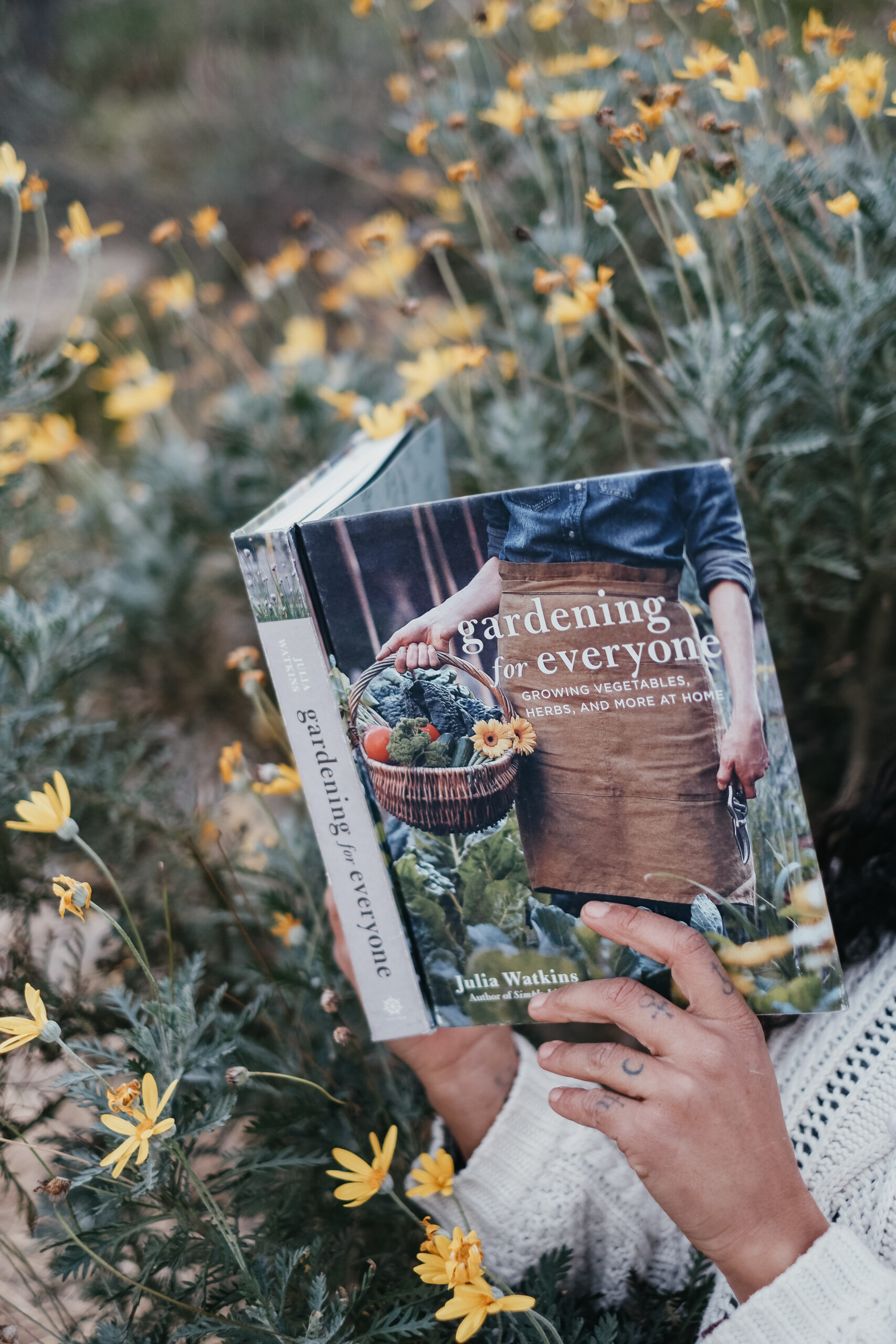 woman reading Gardening for Everyone book