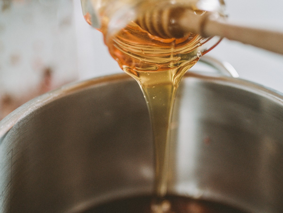 pouring honey into a pan