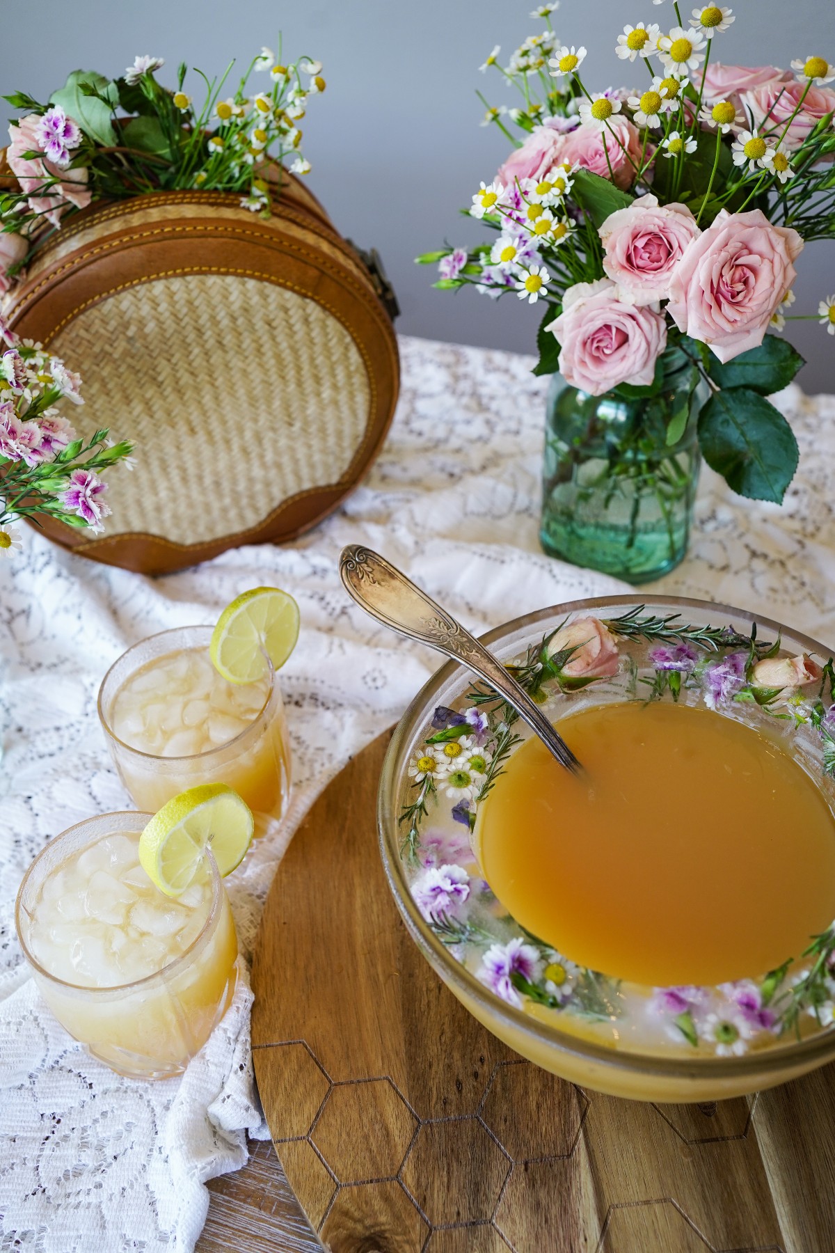 floral ice ring in bowl of punch with glasses of punch and a jar of flowers
