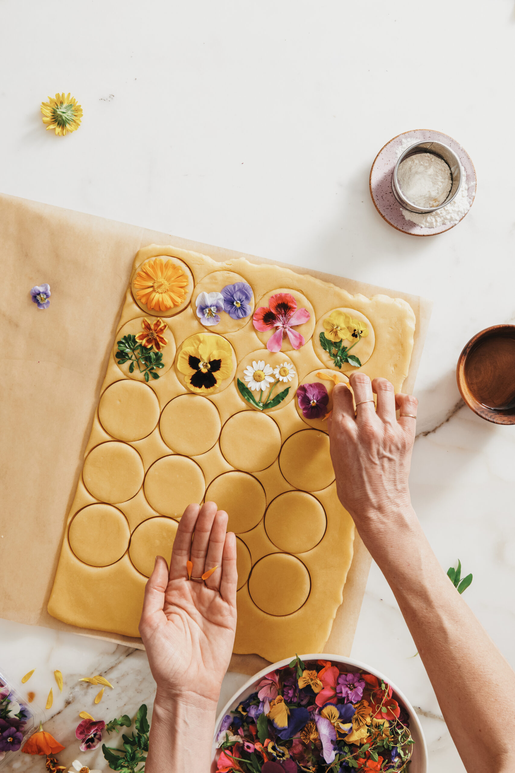 pressing flowers onto shortbread cookies