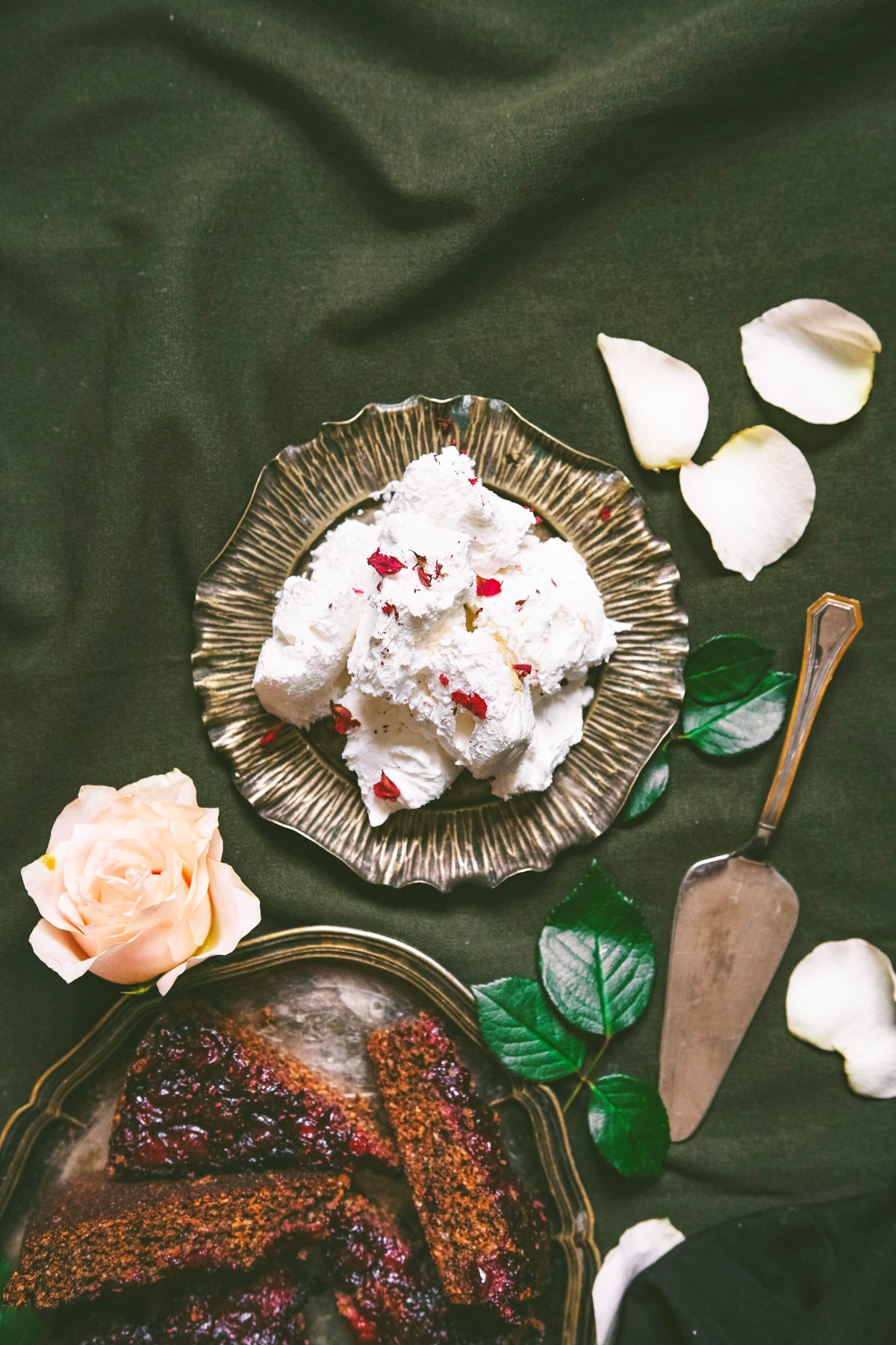 rose ice cream in a silver bowl with flower petals sprinkled around