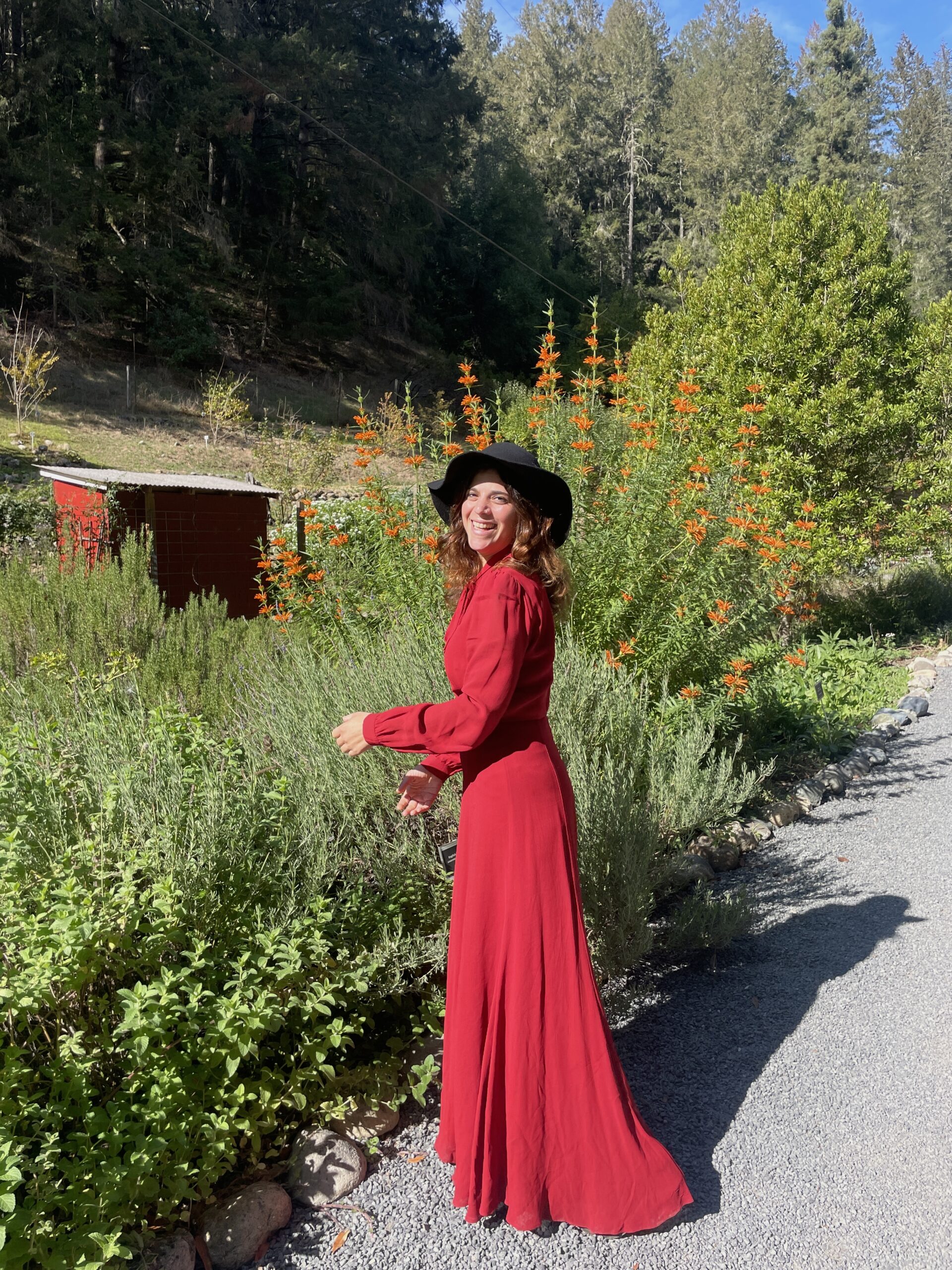 Laura Rubin in a red dress among flowers