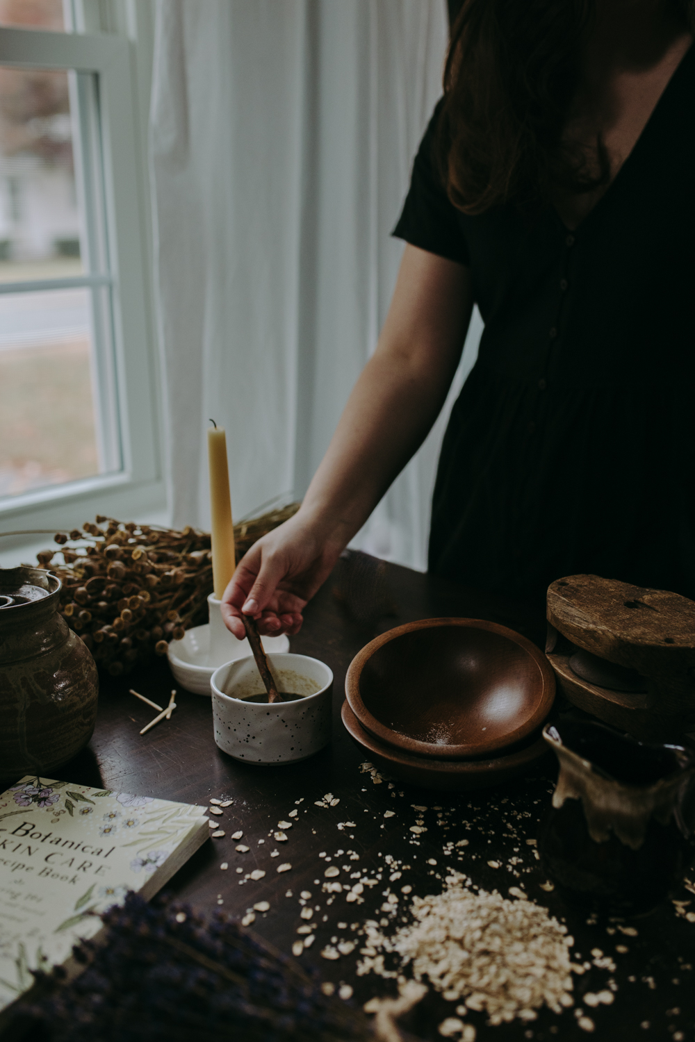 woman stirring herbs in a bowl