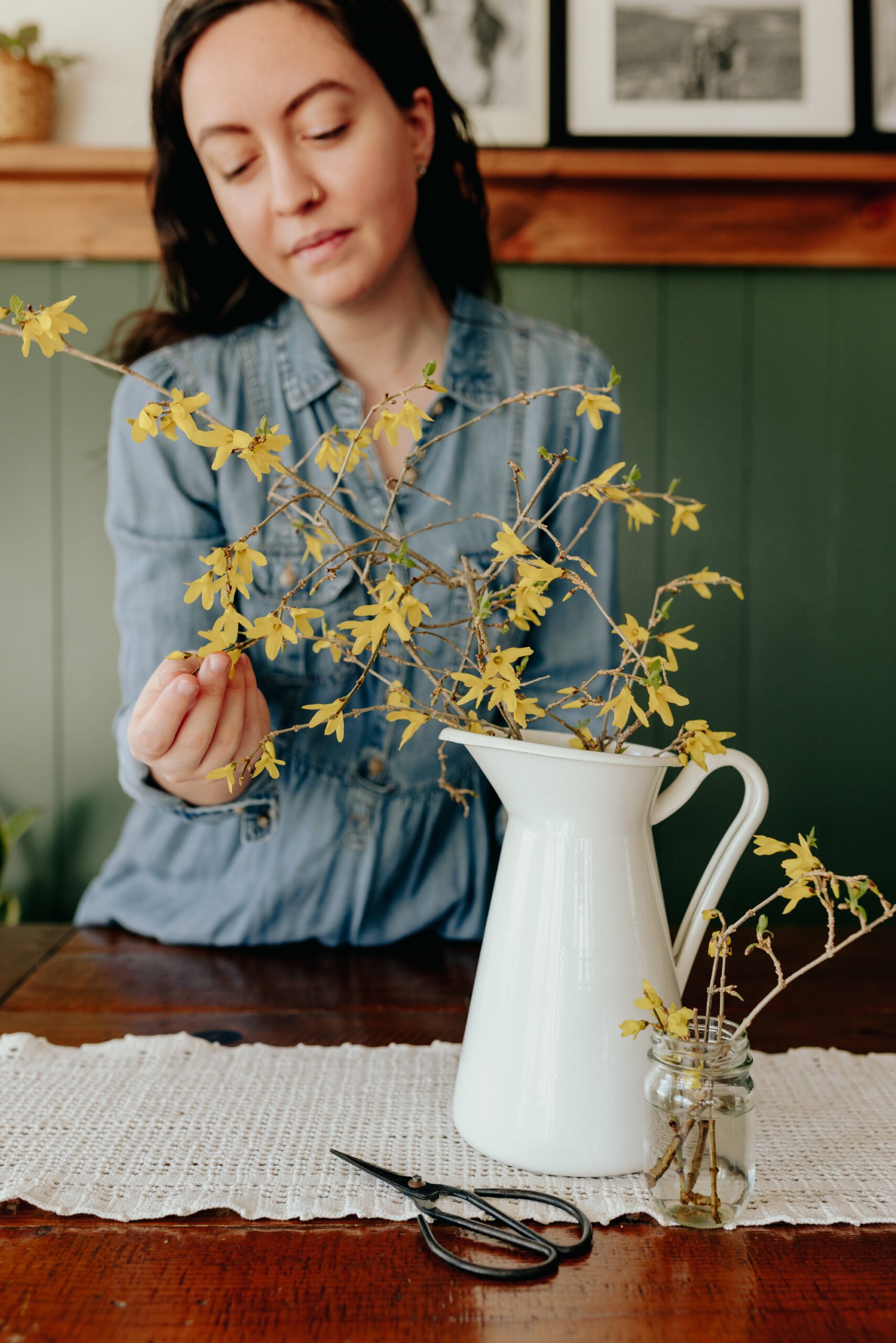 Dagny Kream touching yellow flowers