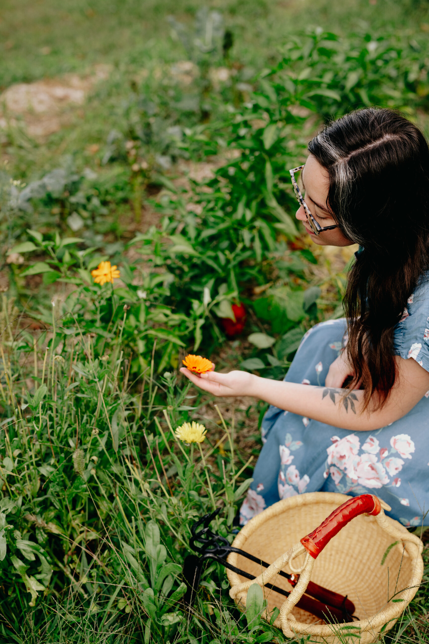 woman touching a flower growing outside