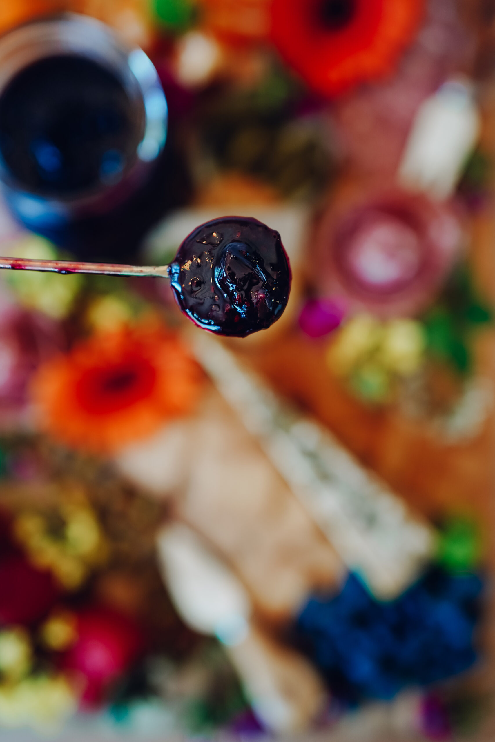 elderberry and blueberry jam on a spoon