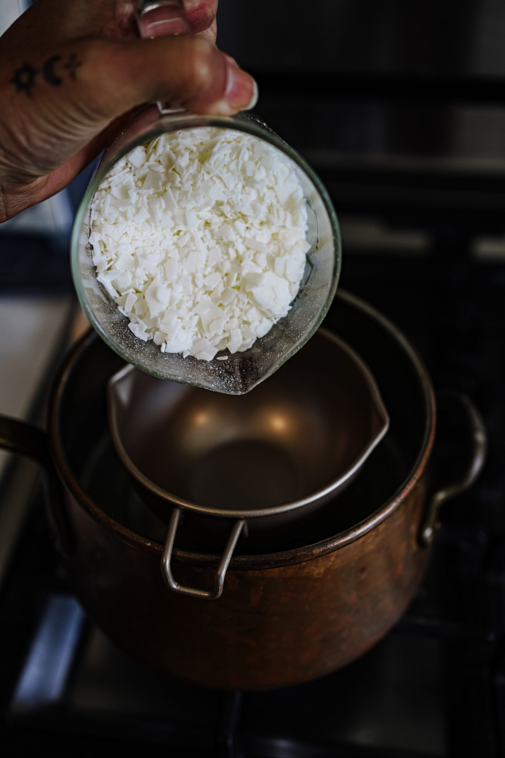 pouring soy wax into a double boiler