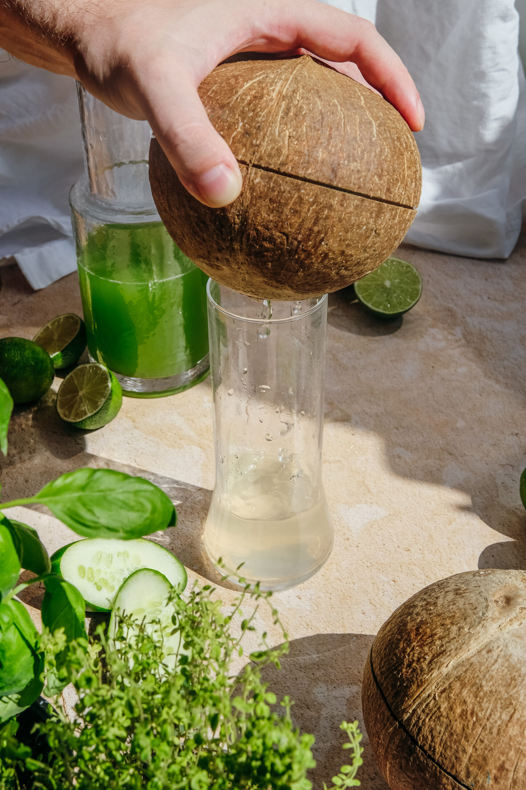 coconut water pouring into a glass from a coconut