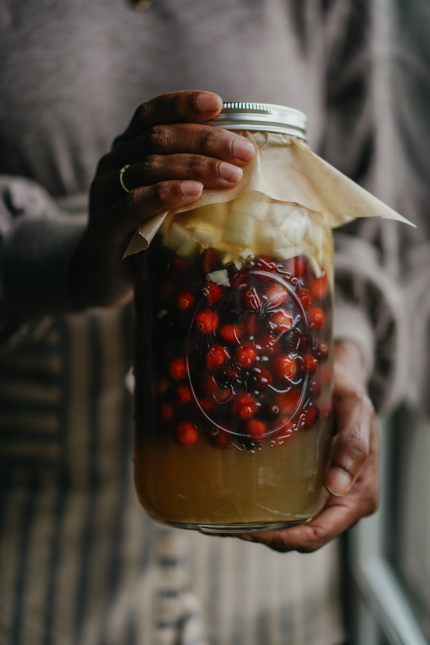 herbalist holding a jar of fire cider 